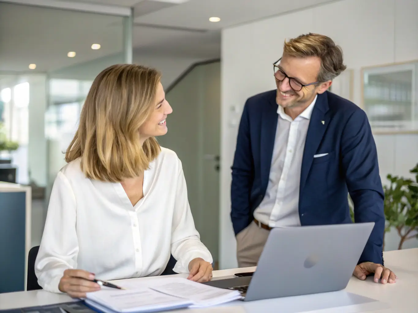 A dedicated account manager assisting a client with their financial planning, highlighting the personalized service offered by INVESTKREDIT BANK AG.